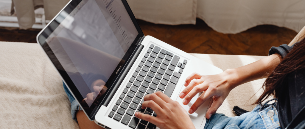 Top view of hands on a laptop with a document open